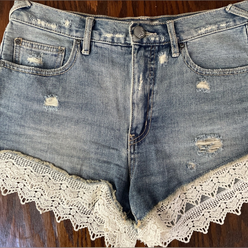 Free People denim jean shorts with lace edge. W28
